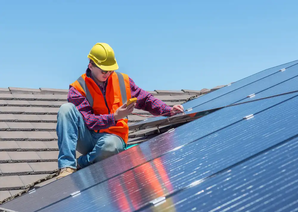 man installing solar panels